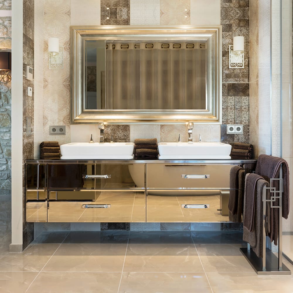 statement furniture, bronze mirrored vanity unit, 2 white basins, gold taps, mirror above