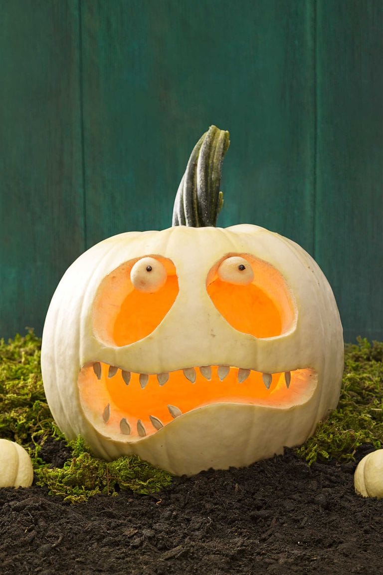 Halloween decor, carved white pumpkin with scared face