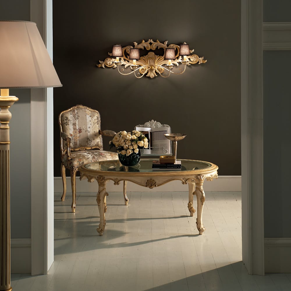 Florence Collection luxury furniture, coffee table and chair underneath ornate wall light