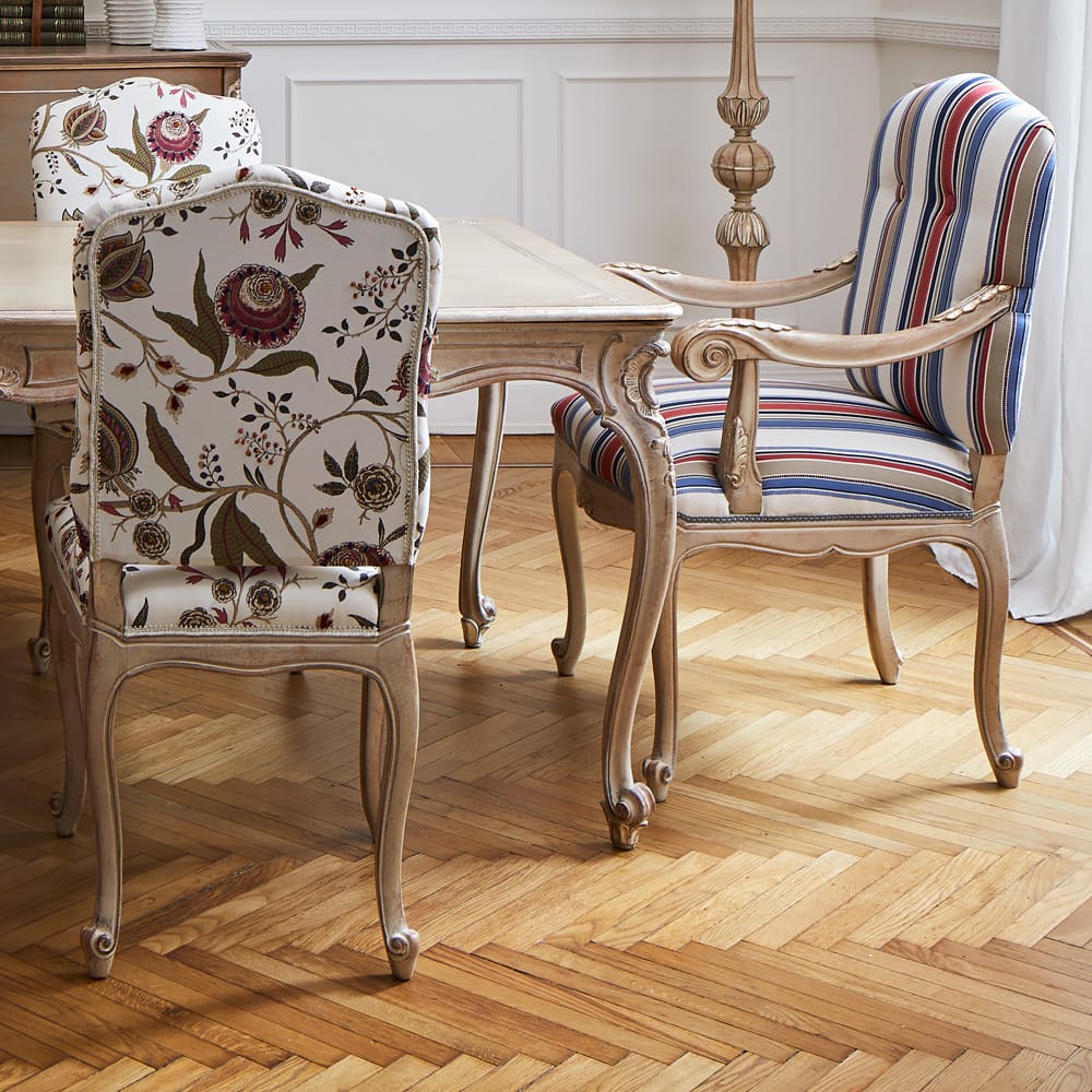 Impress the guests, classic carved wooden dining chairs, one in stripy fabric, others floral