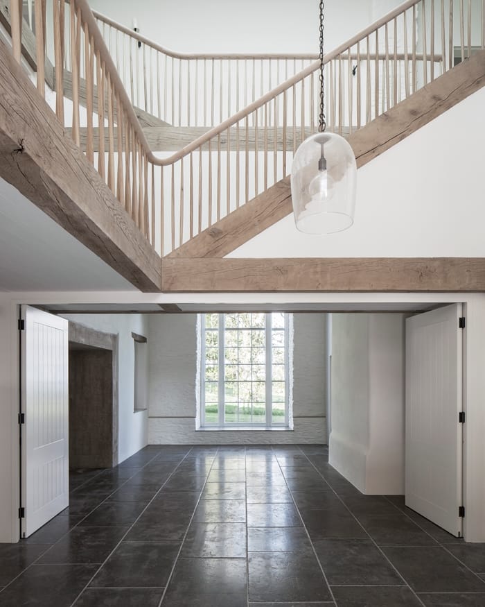 Coastal House living space with full height window and wooden staircase RIBA Awards 2018