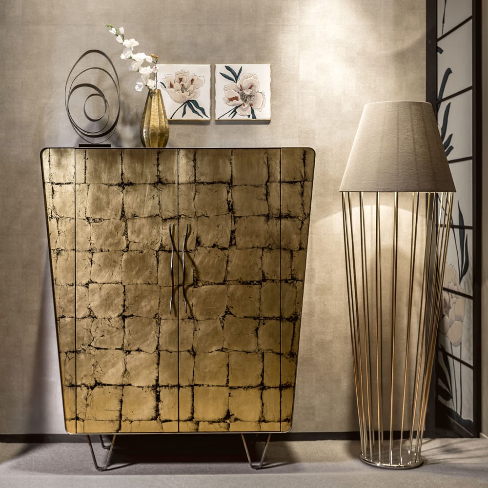 Impress the guests, modern cabinet with antiqued gold square decoration, black modern feet, trapezoid shape