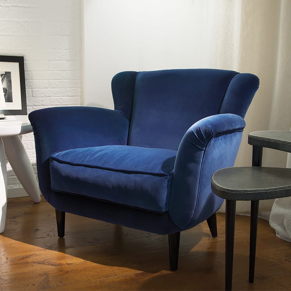 large, comfortable blue velvet armchair