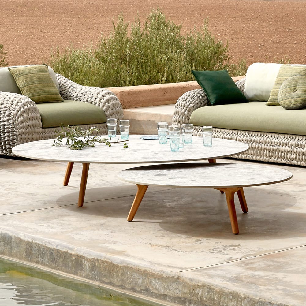 outdoor furniture, two circular contemporary coffee tables, white faux marble top