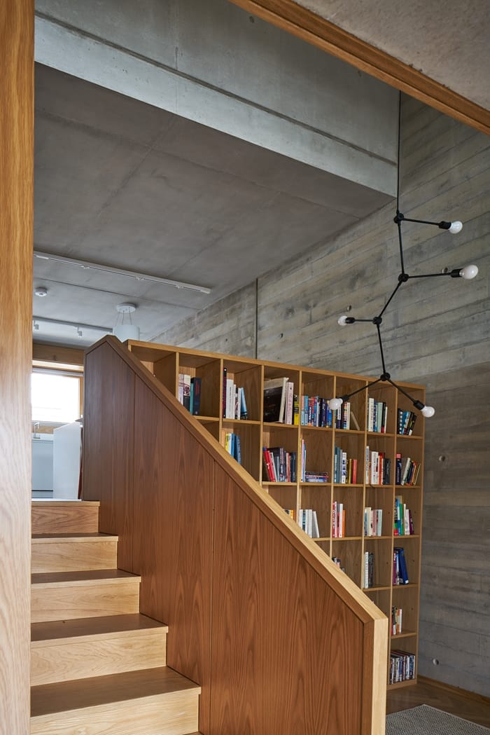 Weston Street Interior with wooden stairs, bookcase, patterned concrete walls, RIBA Awards 2018