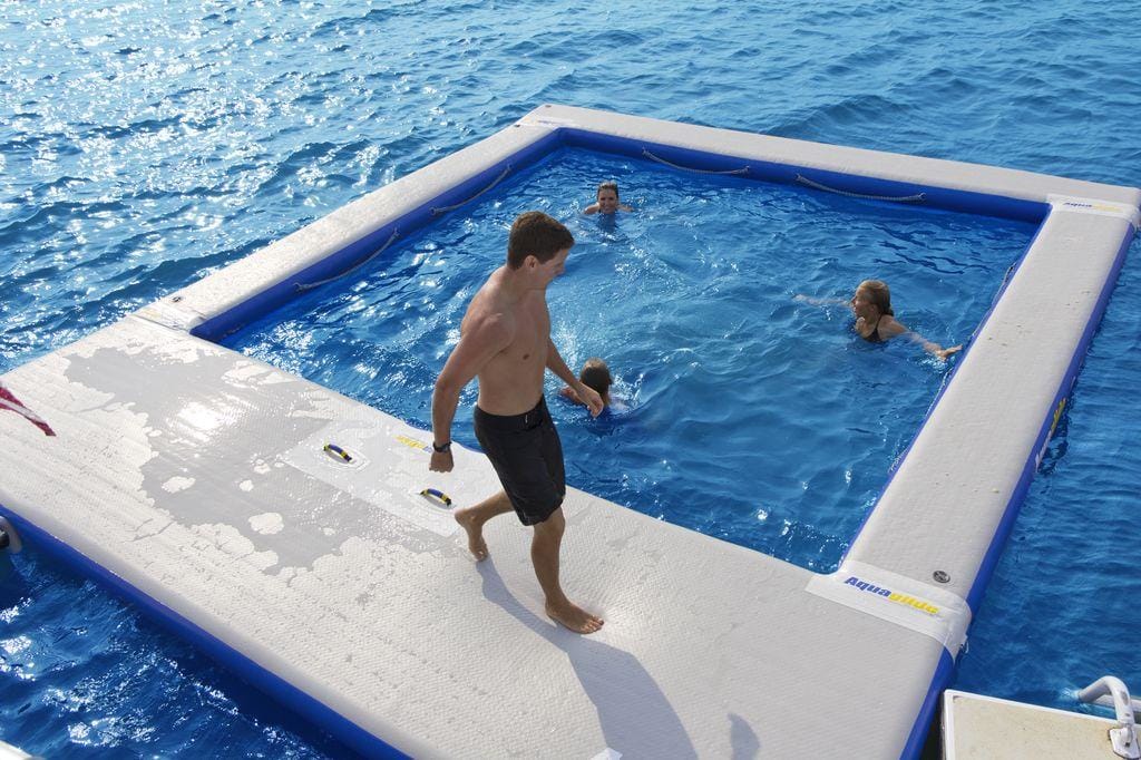 Yacht toys, inflatable sea pool, 2 people in the water, 1 person walking around the edge