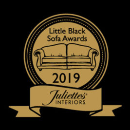 A gold circular emblem reads "Little Black Sofa Blog Awards" and "2019" around an illustration of a sofa. Below, a gold ribbon displays the text "Juliette's Interiors" against a black background.