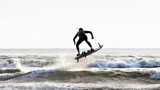 Yacht toys, person on a motorised surf board, small waves