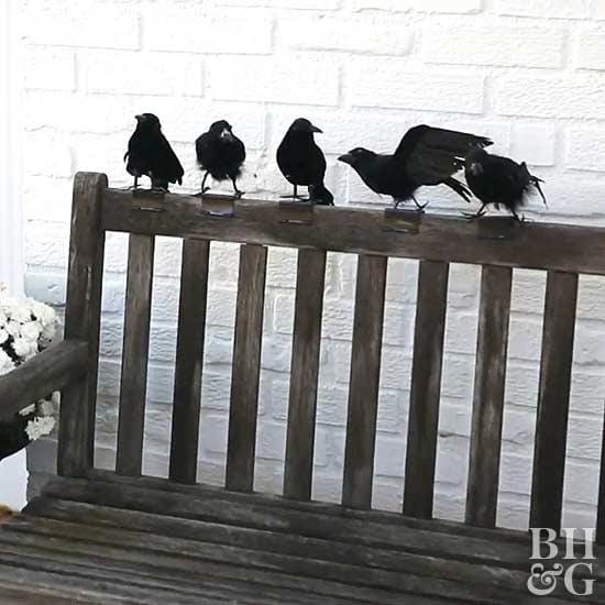 Halloween decor, outdoor bench with crows perched on the back