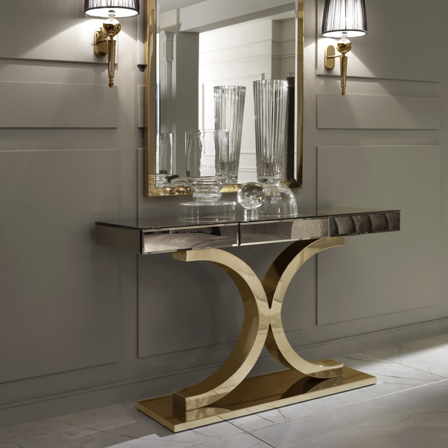 Console table with a bronze mirrored glass top and curved gold-finish frame