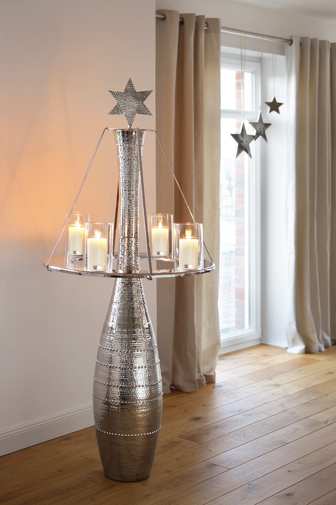 Christmas dining, tall nickel candlestick with star and hoop decoration