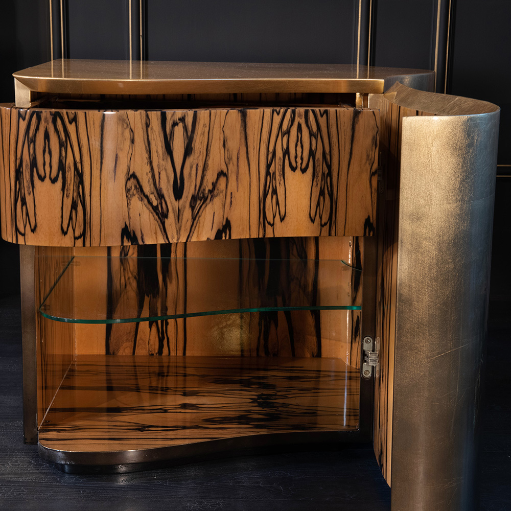 Part of our luxury furniture collection, this luxurious wooden sideboard boasts intricate dark wood grain patterns and a glossy finish. It features a glass shelf inside, visible through the open door. The design includes curved edges, creating an elegant and sophisticated look against a dark, modern background.