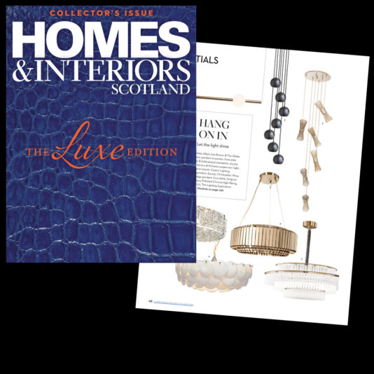 A magazine cover titled "Homes & Interiors Scotland" with the subheading "Collector's Issue: The Luxe Edition" on a textured blue background. An interior page features images of hanging chandeliers and lighting fixtures.