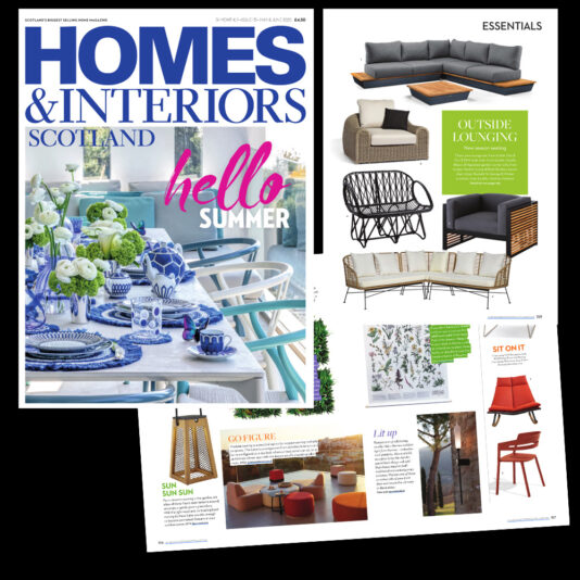 A magazine cover titled "Homes & Interiors Scotland" with the headline "hello summer," featuring an outdoor dining scene with a blue and white table setting. The interior pages display furniture and decor items, including chairs, sofas, and outdoor lighting.