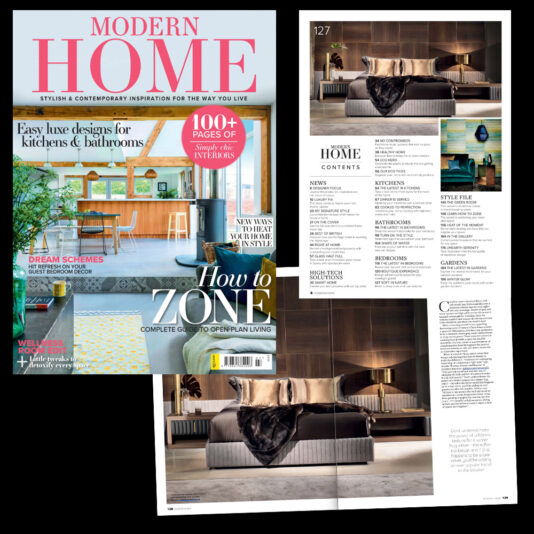 A magazine titled "Modern Home" features a stylish open-plan kitchen on the cover and inside pages showcasing a modern bedroom with cozy decor. The contents section lists topics like kitchens, bathrooms, and more. The overall theme emphasizes contemporary home inspiration.