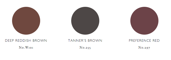 Three color swatches are displayed in a row on a white background. The colors, including the trendsetting "Preference Red" which is celebrated as the colour of the year, are labeled as: Deep Reddish Brown, No. W101 (a dark brown with red undertones), Tanner’s Brown, No. 255 (a deep, dark brownish-gray), and Preference Red, No