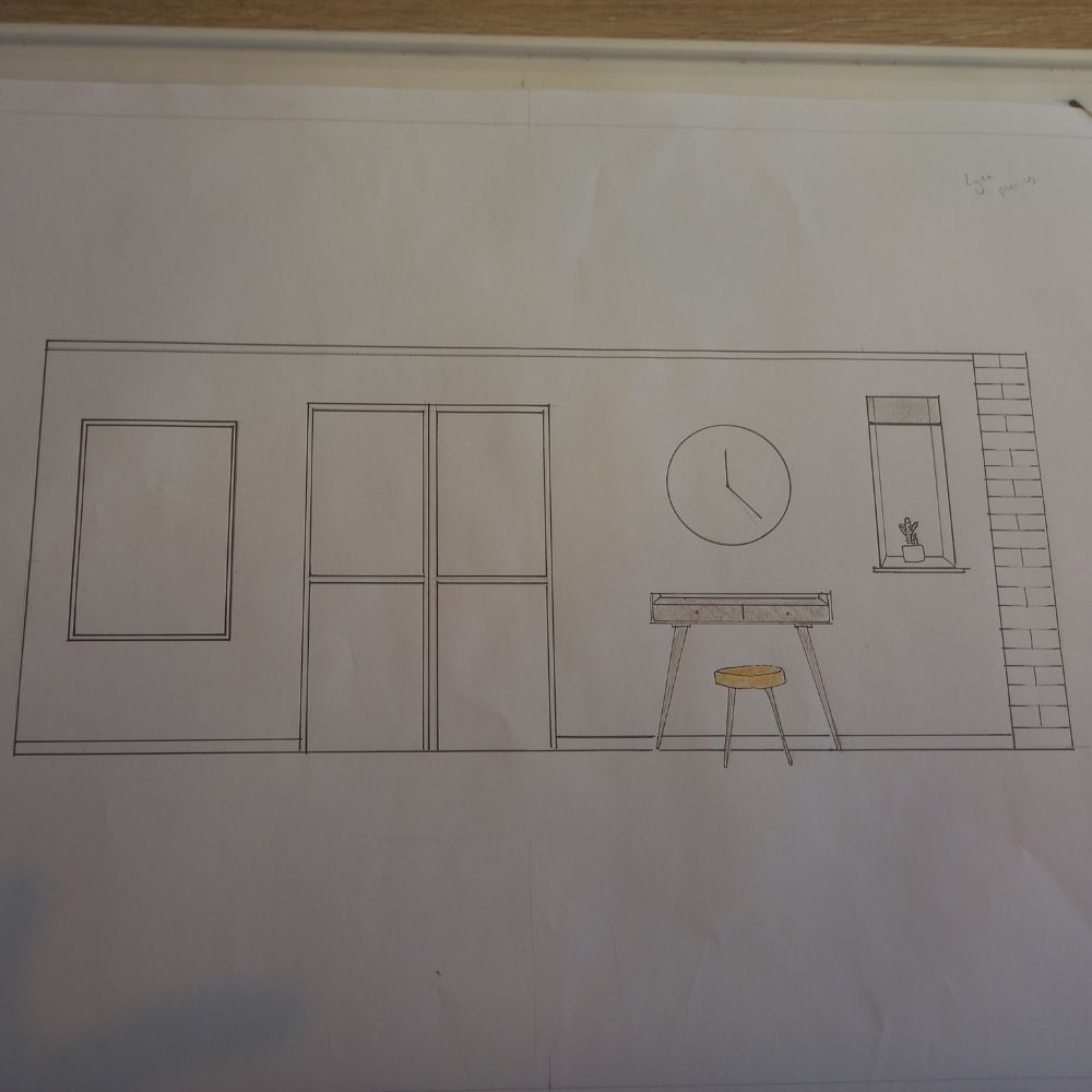 A simple line drawing of a room interior, featuring elements you'd encounter in an interior design course: a large window, a sliding door, a stool, a desk with a potted plant on top, a circular wall clock, and a brick-patterned section near the upper right. The drawing is on a white sheet of paper.