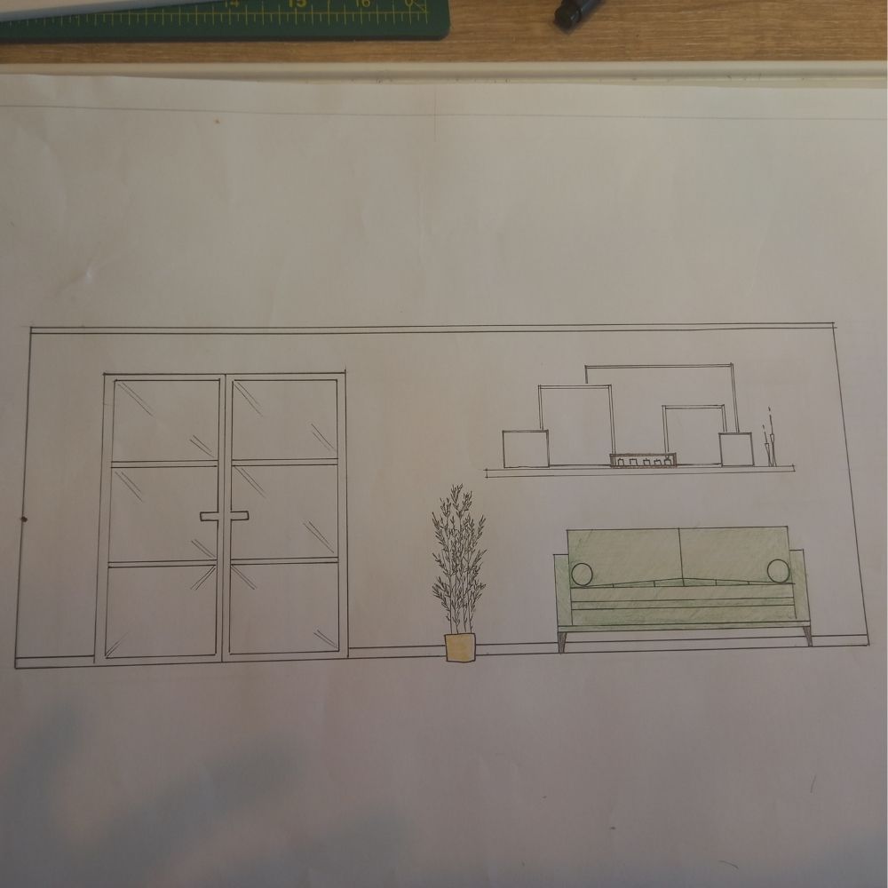 A minimalist room sketch, perfect for an interior design course, features double glass doors on the left, a plant in a pot beside the doors, a green couch with cushions, and a shelf above the couch adorned with decorative items. The sketch is drawn on white paper with a ruler at the top edge.