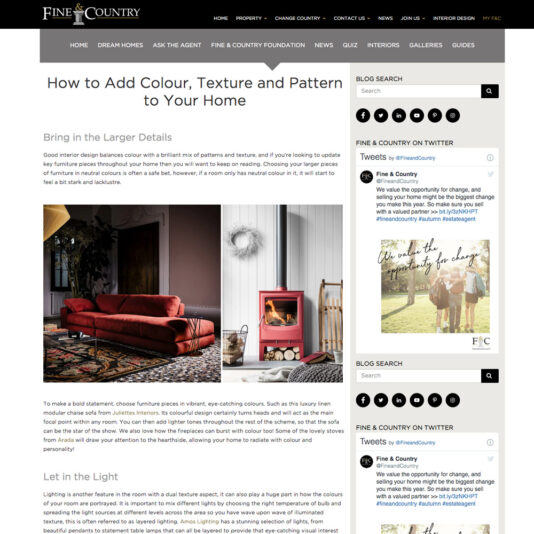 A website article describes how to add color, texture, and pattern to your home decor. It features a cozy living room scene with a red armchair, patterned cushions, a wooden coffee table, and a lit fireplace. The page includes blog search, social media links, and navigation menus.