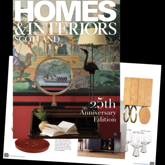 Cover of "Homes & Interiors Scotland" Collector's Issue, 25th Anniversary Edition. The cover features a luxurious home interior with a scenic, antique-style wall mural, a round mirror reflecting the mural, and elegant furnishings, including books and decor items.