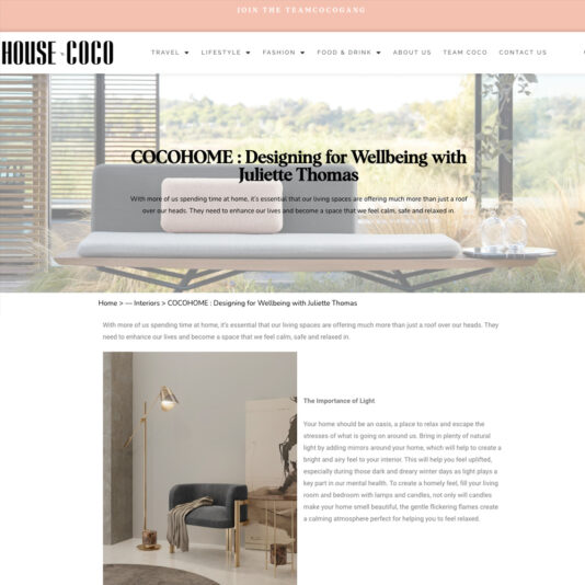 Screenshot of House of Coco's article titled "COCOHOME: Designing for Wellbeing with Juliette Thomas." The page features a stylish indoor setting with modern furniture and decor. The article discusses creating spaces that foster wellbeing.