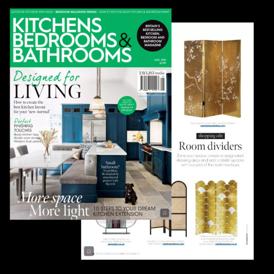 A magazine cover featuring a kitchen with blue cabinetry, a kitchen island, and bar stools. Text reads "Kitchens Bedrooms & Bathrooms" and "Designed for Living". Another section highlights "Room dividers" with images of stylish screens. Various headlines appear.