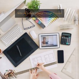 A workspace is shown with various tools and devices for interior design. On the desk are a computer, a tablet, a keyboard, a mouse, a calculator, architectural drawings, color swatches, and stationery. Text at the top reads "WIN an exclusive online interior design course.