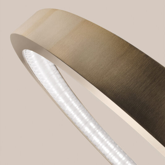 Close-up of the Contemporary Round Chandelier, featuring a brushed gold finish in a circular design. It emits soft white light from its inner ring against a neutral beige background.