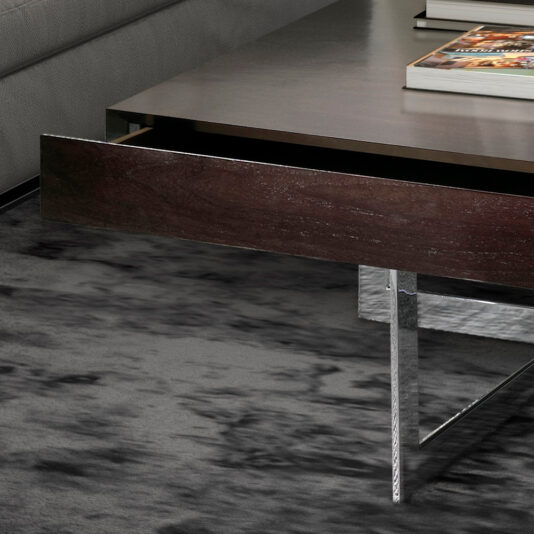 Modern Square Coffee Table With Drawers The Modern Square Coffee Table With Drawers showcases a dark wooden drawer that is partially open, highlighting its sleek design. The table stands on metallic legs and is placed on a textured grey carpet, with a few books stacked neatly on top.