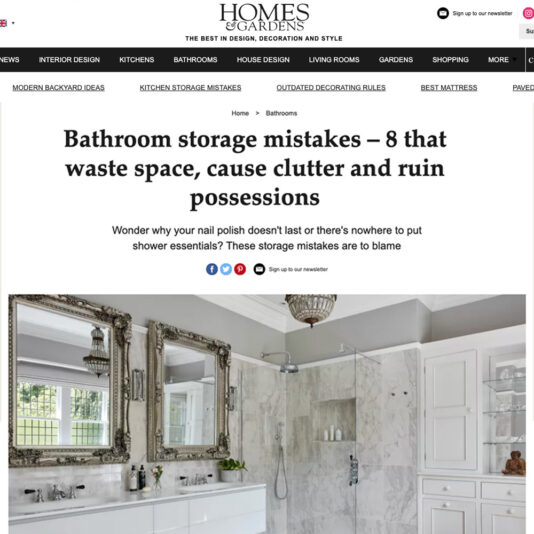 A screenshot of a Homes & Gardens article titled "Bathroom Storage Mistakes – 8 that waste space, cause clutter and ruin possessions." It features a marble-tiled bathroom interior with two mirrors, a sink, and various storage solutions.