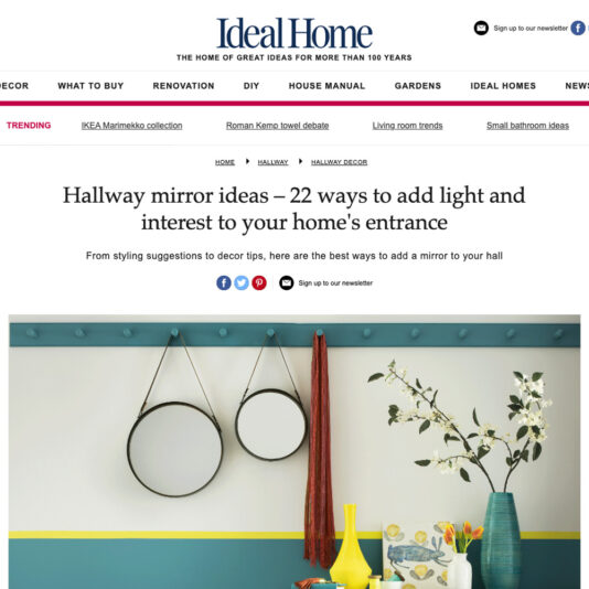 Screenshot of an Ideal Home article titled "Hallway mirror ideas – 22 ways to add light and interest to your home's entrance." The article includes a header image featuring two round mirrors and decorative items such as colorful vases and a flower display.