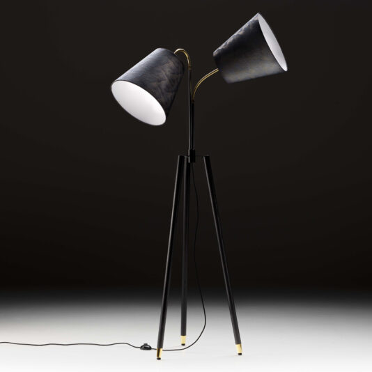 The Large Modern Studio Style Floor Lamp is a sleek, black floor lamp featuring two adjustable cone-shaped shades on a tripod base. The shades boast a metallic finish, complementing the power cord and switch included with the lamp. Set against a plain, dark background, this impressive piece highlights its contemporary studio-style design.