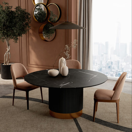 Round Contemporary Stone Effect Dining Table A modern dining room featuring a Round Contemporary Lacquered Dining Table, three pink velvet chairs, decorative vases, a large potted plant, and circular mirrors on a brown wall; city view seen through tall windows.