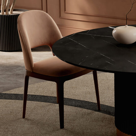 Modern Dining Chair A modern dining area features the Modern Dining Chair in beige upholstery next to a round stone-effect dining table atop a light rug, with decorative wall paneling and a minimalist vase on the table.
