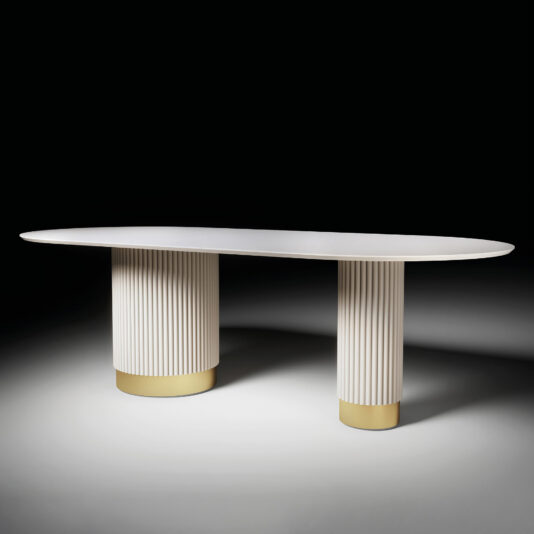 The Round Contemporary Lacquered Dining Table (Copy) features a modern oval shape, two sturdy grooved cylindrical bases with gold-colored bottoms, and is displayed against a dark background.