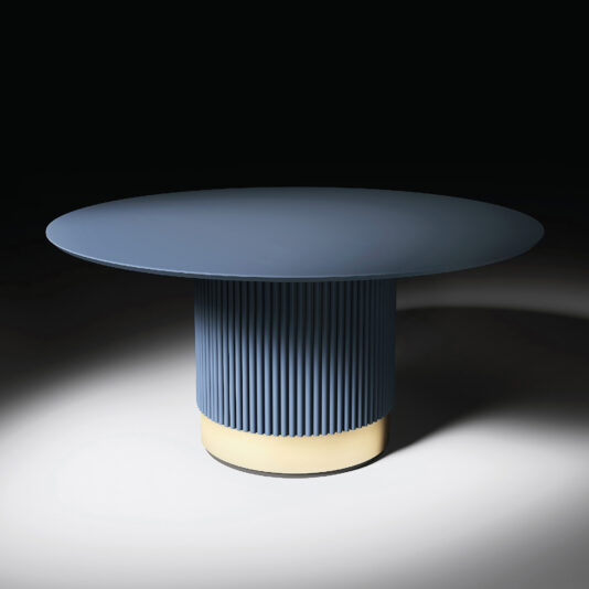 The Round Contemporary Lacquered Dining Table features a smooth round top and a fluted cylindrical base with a glowing light near the bottom, shown against a dark background for a modern look.