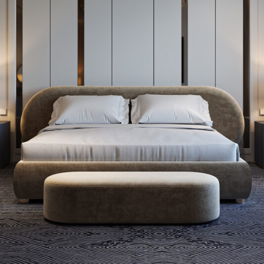 A modern bedroom with a large upholstered bed, white bedding, two pillows, an oval bench at the foot, and Modern Ribbed Lacquered Bedside Drawers (Copy) under soft lighting and minimalist décor.