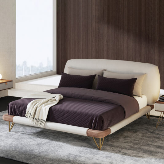 High End Contemporary Italian Bed A modern bedroom showcases the High-End Contemporary Italian Bed with a low white upholstered frame, dark bedding, two pillows, a light throw blanket, gold legs, set on a grey rug by a large window and wooden feature wall.