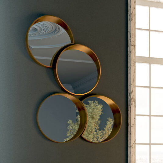 The Modern Floating Wall Mirror Cluster showcases four round gold-framed mirrors in a diamond layout on a dark wall, reflecting a decorative ceiling and lush tree branches from a window nearby.