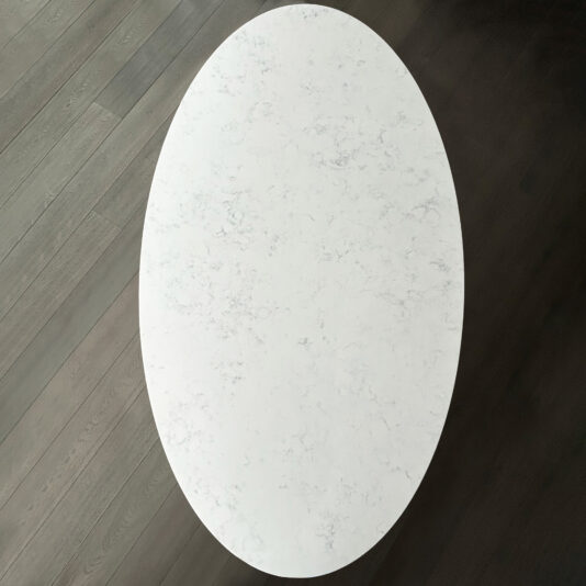 Close-up of white quartz surface and dark wood floor