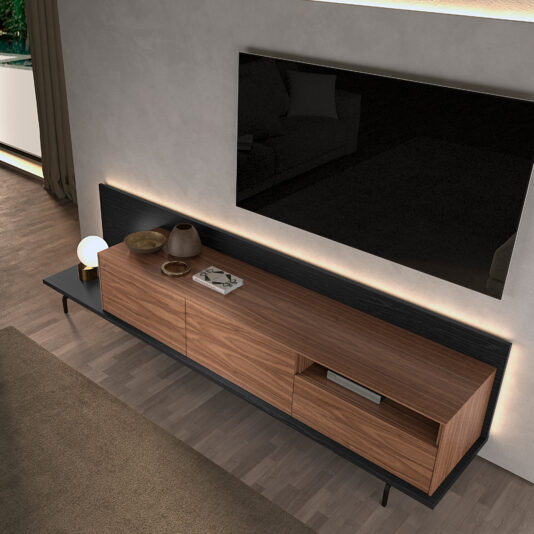 Walnut Veneer Media Sideboard A modern living room features the Walnut Veneer Media Sideboard against a light wall, topped with decor, a large flat-screen TV mounted above, and natural light coming in from the left window.