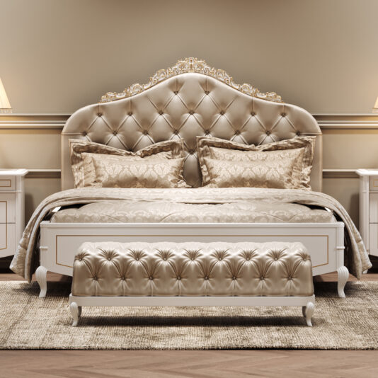 Luxurious bedroom with an ornate, tufted headboard, matching bedding, and a tufted bench at the foot of the bed. Two bedside tables with lamps flank the bed, all in soft, beige and gold tones.